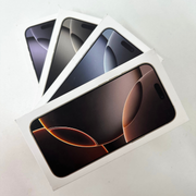 Four Apple iPhone 16 Pro Max smartphones in different colors displayed in their packaging.